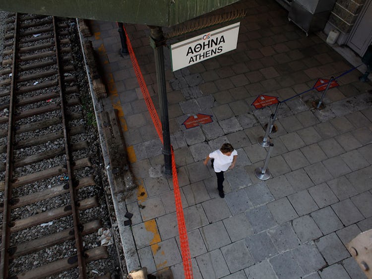 En renhållningsarbetare går genom den övergivna centralstationen i Athen under den dygnslånga generalstrejken tisdagen den 16 juli.