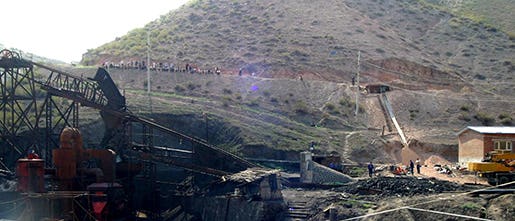 Rescue workers mingle near the entrance to the Shenlong Coal Mine in Fukang, northwestern China's Xinjiang region, Monday, July 11, 2005. An explosion in the coal mine in China's far west has killed at least 41 people, with 42 others still missing, the official Xinhua News Agency said Monday. The blast occurred at 2:30 a.m. (1830 GMT, Sunday) in the Shenlong Coal Mine in the Xinjiang region, when about 87 miners were underground, Xinhua said. (AP Photo/EyePress) ** ONLINE OUT, CHINA OUT **