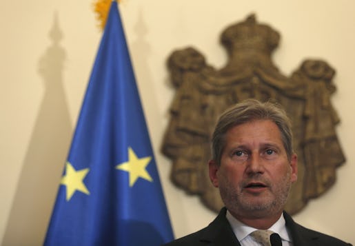 European Commissioner for European Neighbourhood Policy and Enlargement, Johannes Hahn speaks during a press conference after talks with Serbian Prime Minister Aleksandar Vucic, unseen, in Belgrade, Serbia, Friday, Sept. 25, 2015.  Hahn said Friday that the problem with Croatia accusing Serbia of busing migrants to Croatia's border, can be solved only with Croatia reopening its border. (AP Photo/Darko Vojinovic)