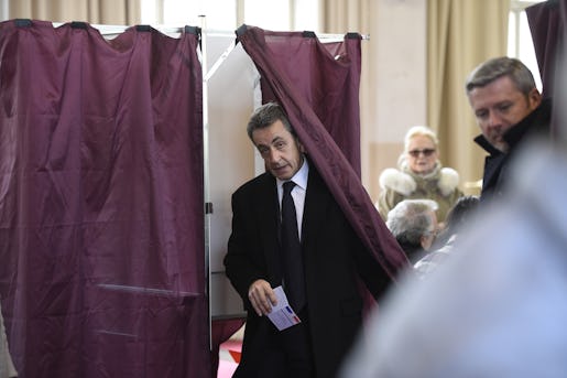 Former French President and current French right-wing opposition "Les Republicains" party leader Nicolas Sarkozy steps out of a polling booth before voting as part of the first round of the regional election at a polling station in Paris, France, Sunday, Dec. 6, 2015. French voters are casting ballots Sunday for regional leaders in an unusually tense security climate, expected to favor conservative and far right candidates and strike a new blow against the governing Socialists. (Eric Feferberg/Pool Photo via AP)