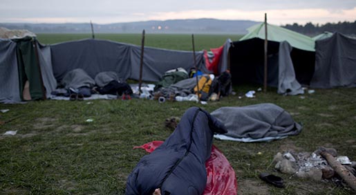 Stranded refugees sleep as they wait to be allowed to cross the Greek-Macedonian border near the northern Greek village of Idomeni, Saturday, Feb. 27, 2016. Greek officials said not a single migrant has been allowed into northern neighbor Macedonia Friday, with nearly 5,000 people waiting at or near a border crossing to be admitted. More than 20,000 migrants are stuck in Greece. (AP Photo/Petros Giannakouris)