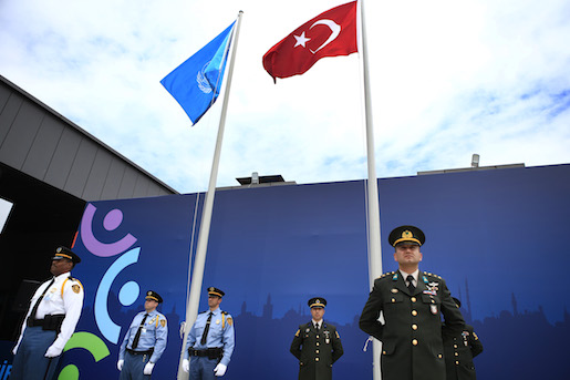 United Nations security personnel, left and Turkish armed forces officers, right, attend a flag raising ceremony, marking the opening of business at the World Humanitarian Summit, in Istanbul, Saturday, May 21, 2016. World leaders and representatives of humanitarian organisations from across the globe converge in Istanbul on May 23-24, 2016 for the first World Humanitarian Summit, focused on how to reform a system many judge broken. (AP Photo/Lefteris Pitarakis)