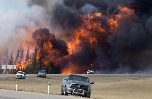 FILE - In this May 7, 2016 file photo, a wildfire burns south of Fort McMurray, Alberta. A dry and blistering hot northern Alberta is burning and doing so unusually early in the year, but thatís only the latest of many gargantuan fires on an Earth thatís grown hotter with more extreme weather. (Jonathan Hayward /The Canadian Press via AP, File) MANDATORY CREDIT