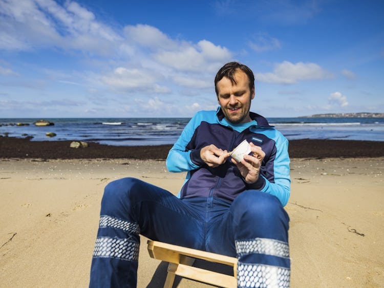 Brevbäraren Joakim Sundbaum på stranden med en bägare egengjord gelato.