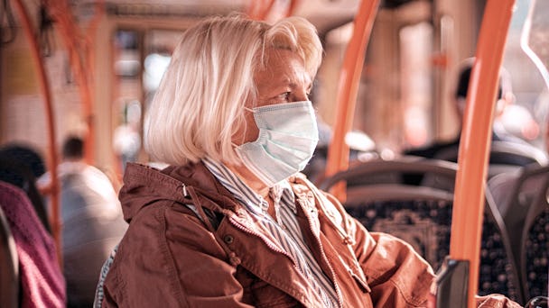 kvinna med munskydd på buss