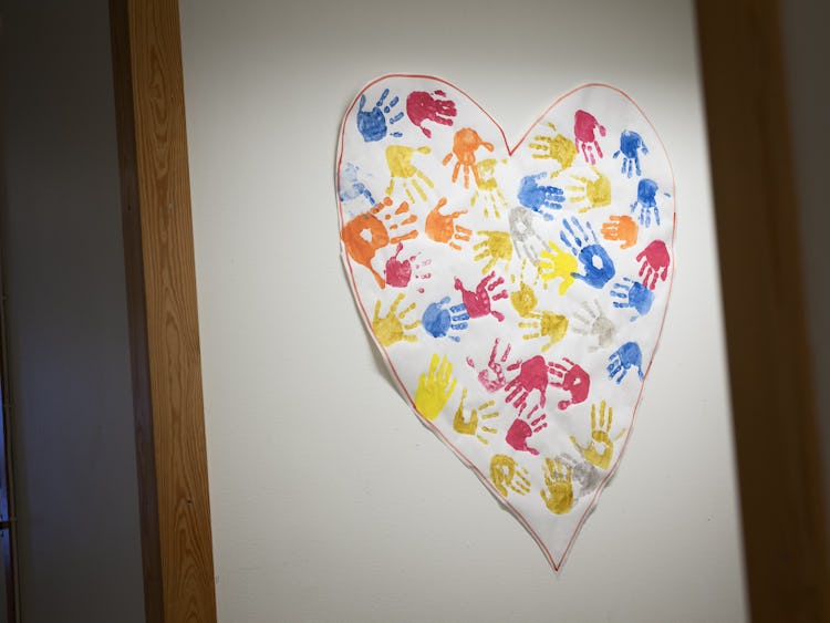 Ett hjärta gjort av handavtryck på en vägg.