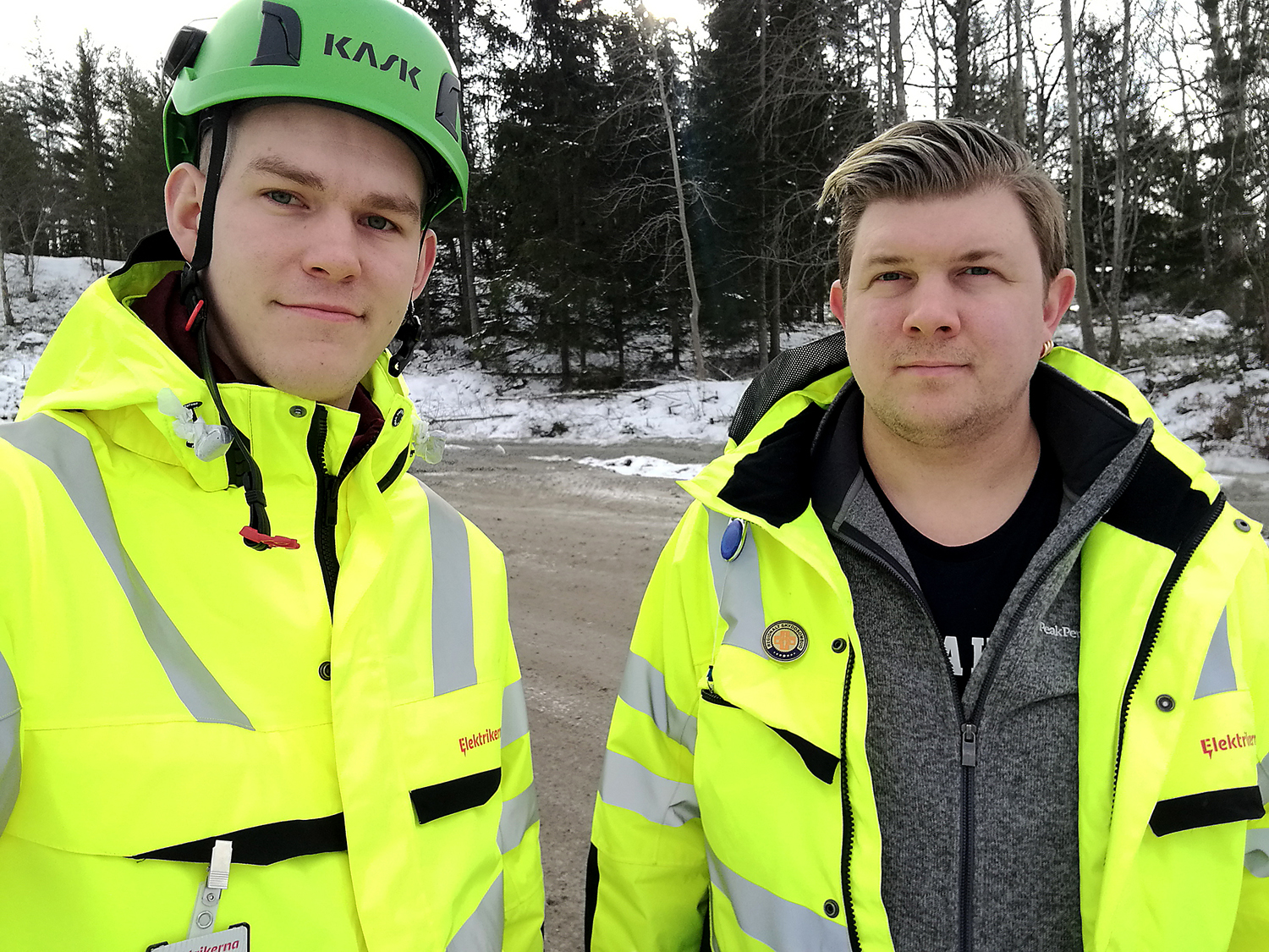 Bilde föreställer Claes Thim och Per Söderlund, med en snöig skog i bakgrunden. Claes har en grön skyddsombudshjälm på sig, och båda är klädda i gula reflexjackor.