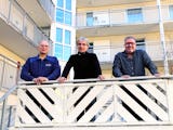 Roger Persson, Arne Forsberg och Mikael Gustafsson tittar ned över räcket på en veranda