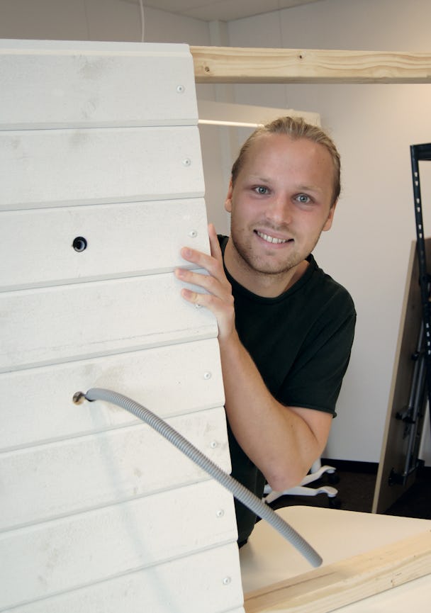 Svante Olsson kikar fram bakom en vägg