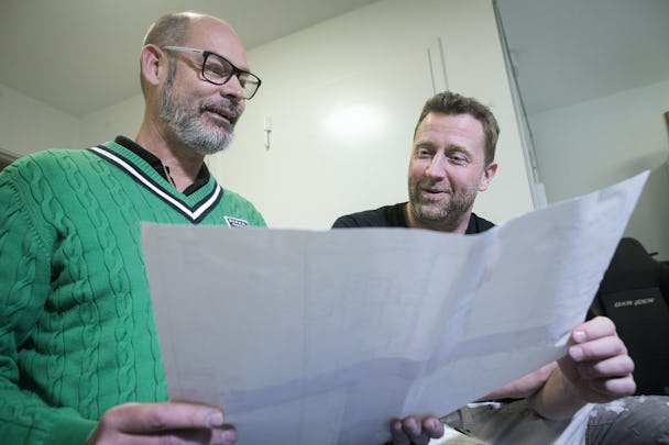Två personer tittar tillsammans på ett stort papper
