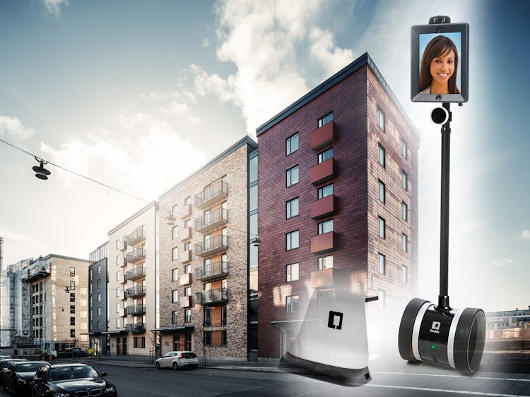 Fasaden på ett lägenhetskomplex med bilden av en robot monterad framför