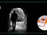 Silhuetten av en person som går genom en mörk tunnel
